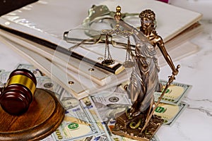 Statue of justice symbol on law office workplace working document with Judge's gavel police handcuffs