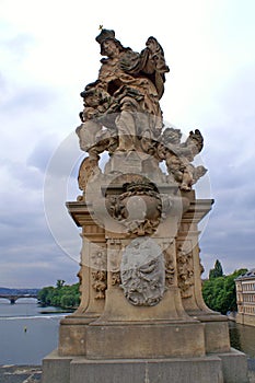 Statue of the King on the Charles Bridge in Prague. Czech Republic. The king is on the throne. Against the background of the river