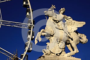 Statue of King of Fame riding Pegasus on the Place de la Concorde with ferris wheel, Paris, France