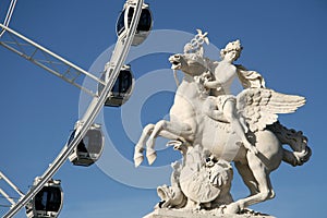 Statue of King of Fame riding Pegasus on the Place de la Concorde with ferris wheel, Paris, France