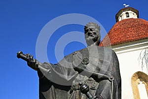 Statue of King Louis I of Hungary with letters of city privileges of Skalica city in his right hand, in front of gothic Charnel