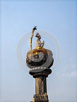 Statue of King Yoga Narendra Malla on a stone pillar at historical site in Lalitpur. Nepal photo