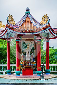 The statue of the Kuan Yin with sky background.