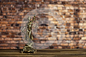 statue of Lady Justice, goddess Justitia, on the desk in a lawyer's office