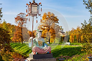 Statue on Large Chinese bridge in Alexander park in autumn, Pushkin Tsarskoe Selo, Saint Petersburg, Russia