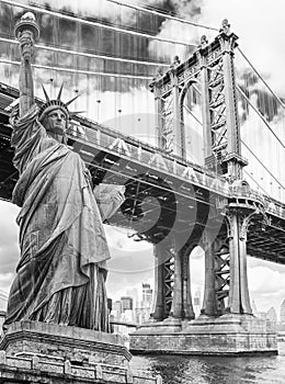 Statue of Liberty against Manhattan Bridge, New York. USA