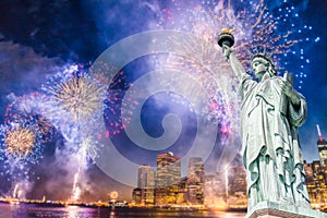 The Statue of Liberty with blurred background of cityscape with beautiful fireworks at night, Manhattan, New York City