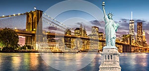 The Statue of Liberty and Brooklyn Bridge with World Trade Center background twilight sunset view, Landmarks of New York City