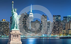 The Statue of Liberty with cityscape in Manhattan at night, New York City