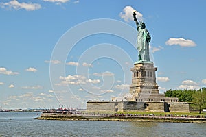 Statue of Liberty looking beyond the wide blue sky background