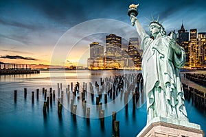 The Statue of Liberty with Lower Manhattan background in the evening