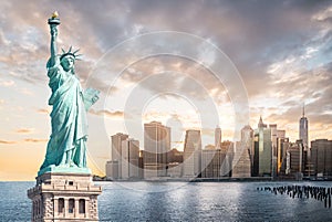 The Statue of Liberty with Lower Manhattan background in the evening at sunset, Landmarks of New York City