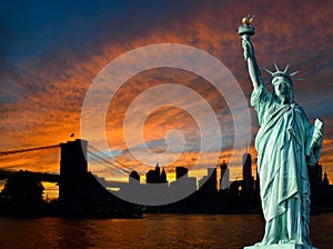 Statue of Liberty and Manhattan at sunset.