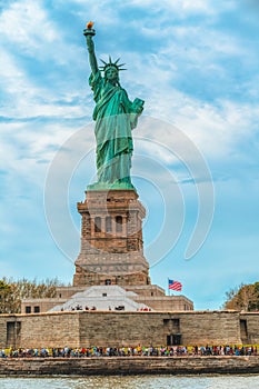 Statue of Liberty on Liberty Island, New York City. Cloudy Blue Sky Background, Vertical Banner