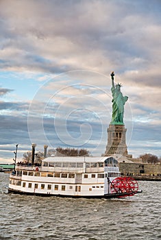 The Statue of Liberty in New York City with ferry boat