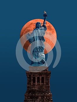 Statue of liberty in new york city usa in front of giant red moon