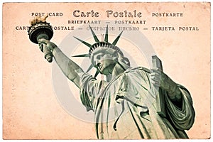 Statue of Liberty in New York, collage on sepia vintage postcard background, word postcard in several languages
