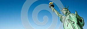 Statue of Liberty in New York, USA. Blue sky panoramic background