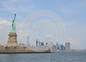 Statue of liberty in New York with water and ferries