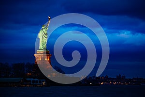 Statue of Liberty over New York night cityscape