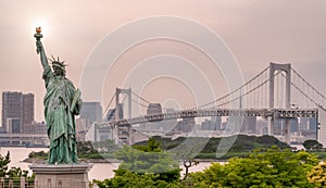 Statue of liberty, rainbow bridge and Tokyo cityscape