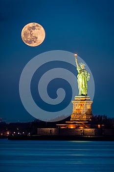 Statue of Liberty and a rising supermoon