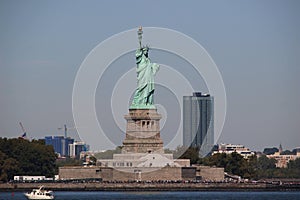 The Statue of Liberty stands proudly at the entrance to Manhattan viewed from the sea