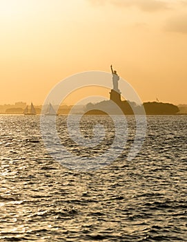 Statue of Liberty before sunset in hazy New York Harbor