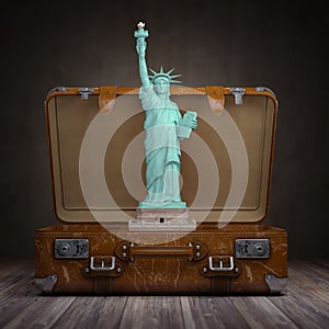 Statue of liberty and vintage suitcase. Travel and tourism to NY New York city and USA concept