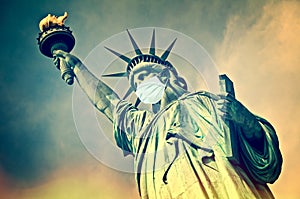 Statue of Liberty wearing a surgical mask. New coronavirus, covid-19 in New York and USA epidemic concept