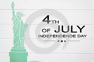 Statue of liberty on white wooden table with the text 4th of July,Independence day