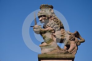 A statue of a lion at the Loewenbrunnen (Lion's Fountain) at the University Square in Heidelberg, Germany.