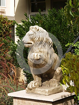 Statue Of Lion With Raised Paw Ornamenting House Entrance