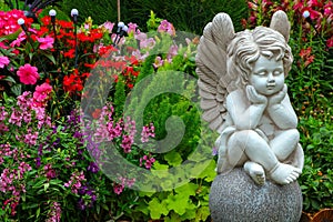 Statue of a little cherub in a tropical garden