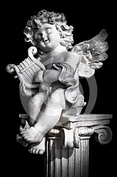 Statue of Little Cupid playing harp