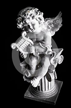 Statue of Little Cupid playing harp