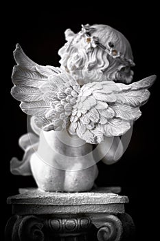 Statue of Little Cupid playing harp