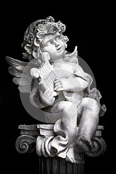 Statue of Little Cupid playing harp