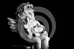 Statue of Little Cupid playing harp