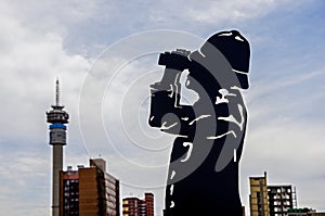 Constitutional Hill Precinct, Johannesburg, South Arfica. A man looking at Hillbrow Tower in Joburg. Metal statue of a man. Symbol