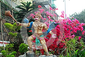 Statuie of Lord Mahaveer in a flower garden photo