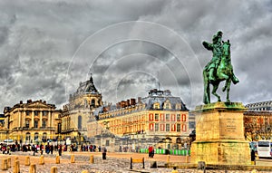 Statue of Louis XIV in front of the Palace of Versailles photo