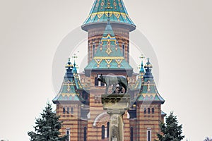 The statue Lupa Capitolina with the Orthodox Metropolitan Cathedral in the background in Timisoara photo