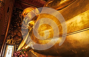 Statue of lying Reclining Buddha in Wat pho Pho Temple Bangkok Thailand, represents the entry of Buddha into Nirvana and the end