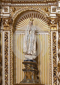 Statue of the Madonna with prayerful hands and a crown inside the Sanctuary of Our Lady of Nazare in Portugal. photo