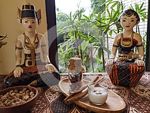 The statue of the male and female couple, & x22;loro blonyo,& x22; in traditional Javanese attire, as an interior element. photo