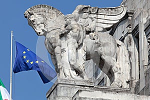 Statue of a man holding a winged horse on the Milan's main railway station