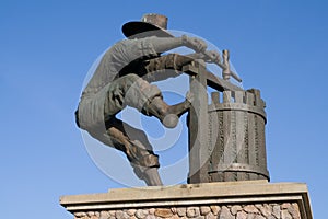 Statue of a man making wine
