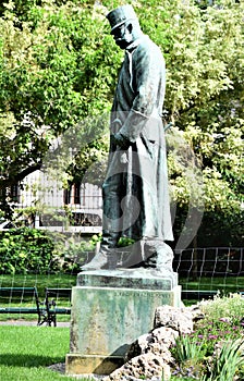 Statue of man in uniform with military cap, in the garden and park in the museum district, in Vienna.