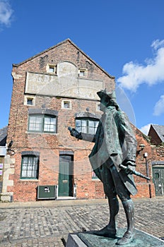 Statue of Maritime figure in front of Warehouse